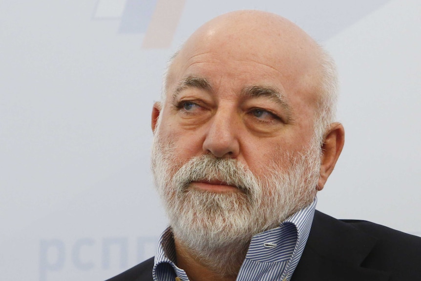 An image of a bearded middle-aged businessman Viktor Vekselberg looking sideways
