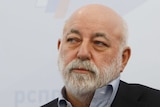 An image of a bearded middle-aged businessman Viktor Vekselberg looking sideways