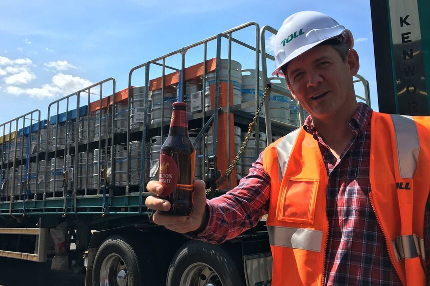 Michael Gunner holds beer at CUB.