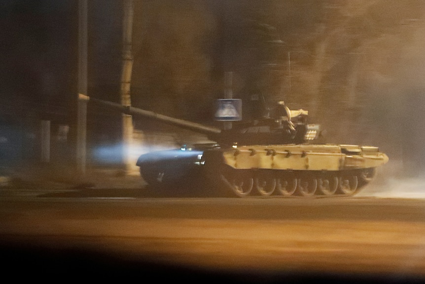 A tank drives along a street in Donetsk