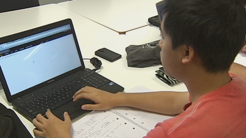 A student works on his laptop