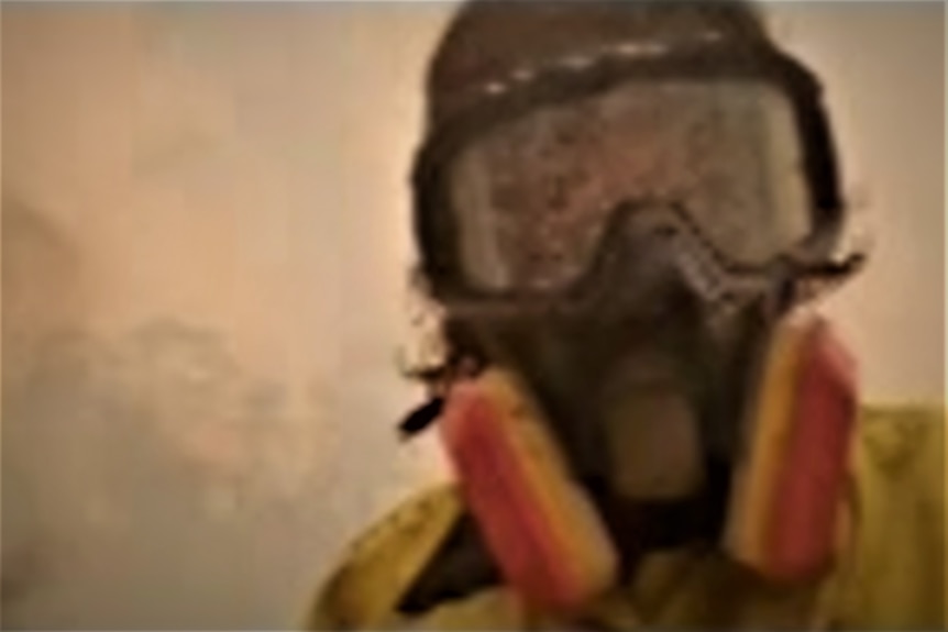 Selfie of in goggles and face mask surrounded by bushfire smoke