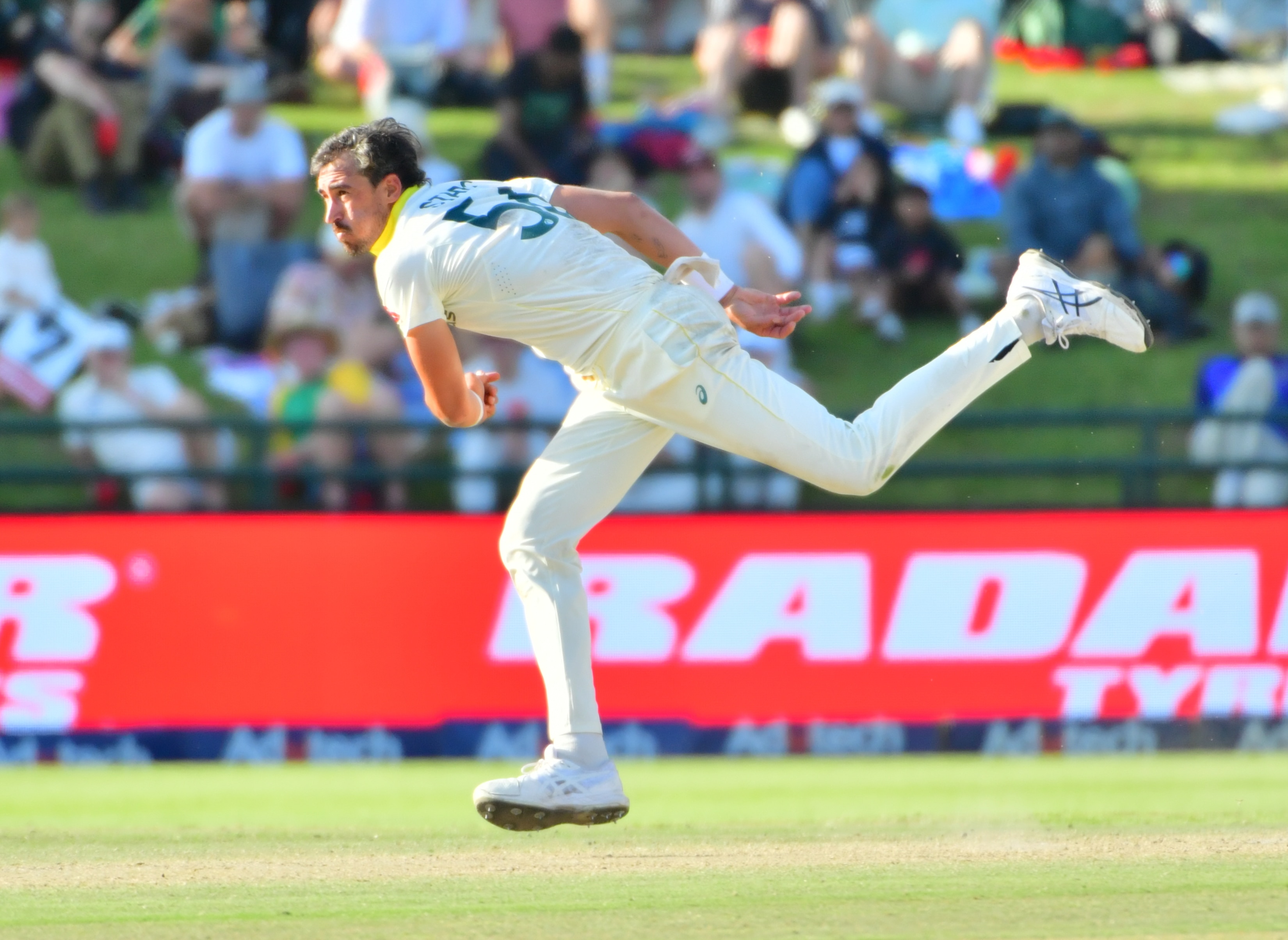 An Australian Test fast bowler pictured in his follow-through after bowling a ball.