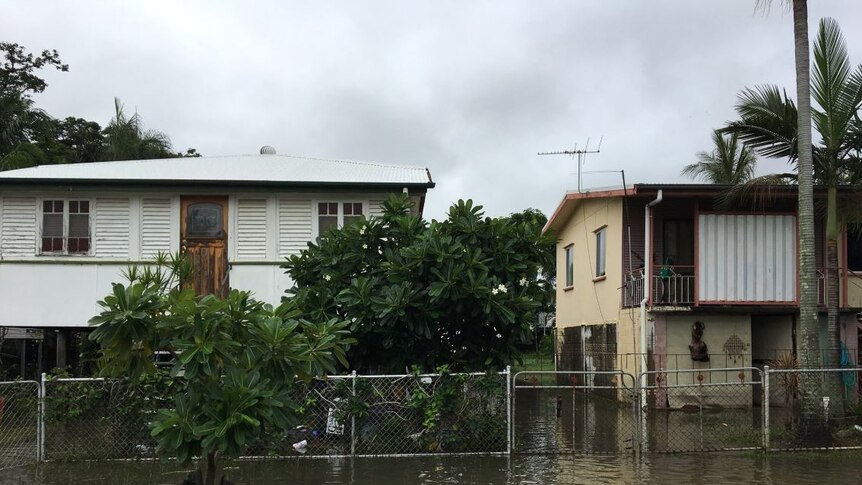 Water is slowly receding in some Townsville suburbs but homes in Railway Estate are still surrounded by water.