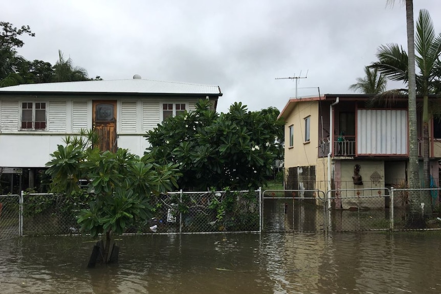 Water is slowly receding in some Townsville suburbs but homes in Railway Estate are still surrounded by water.