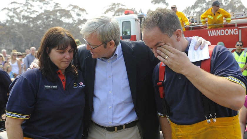PM salutes community: Kevin Rudd hugs CFA members Sandra O'Connor and Frank Amoroso during a visit to Wandong.