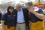 PM salutes community: Kevin Rudd hugs CFA members Sandra O'Connor and Frank Amoroso during a visit to Wandong.