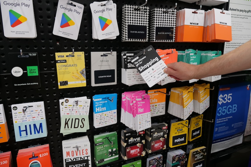 Rows of gift cards on a wall at a supermarket