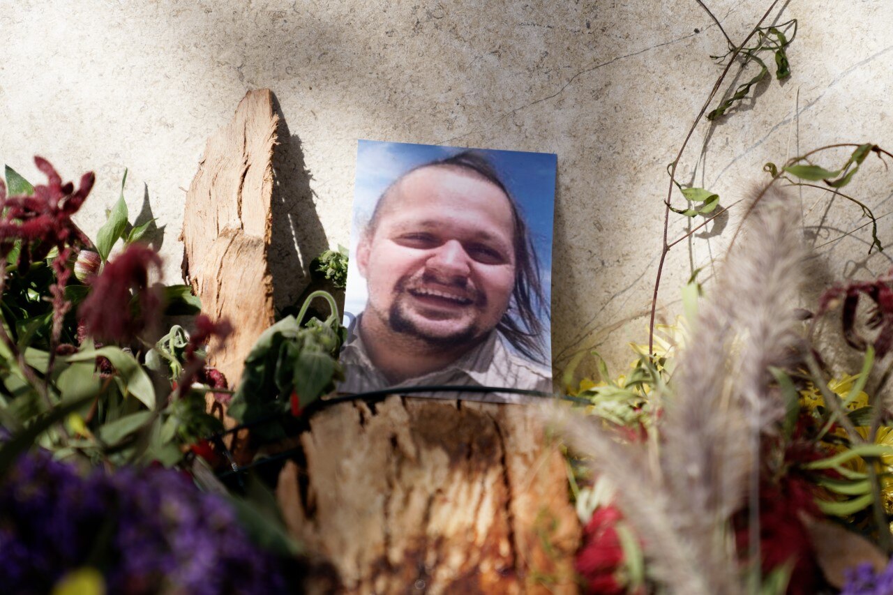 A photo of a man surrounded by flowers