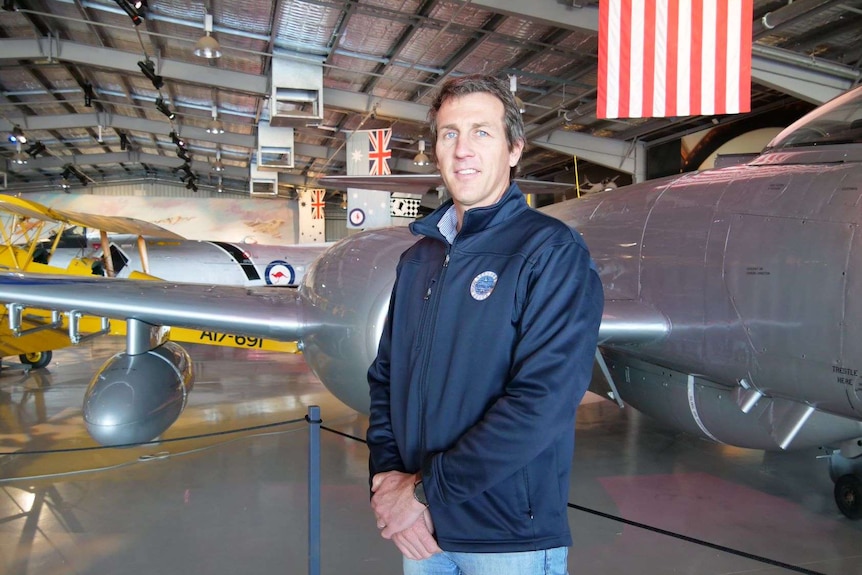 Temora Aviation Museum General Manager Peter Harper standing in front of aircraft