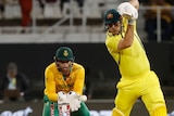 Mitch Marsh plays a drive on the back foot as South Africa's wicketkeeper Tristan Stubbs watches