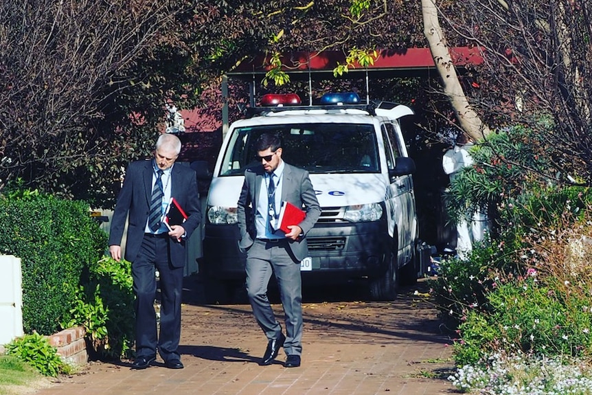 Police in a Millicent house driveway.