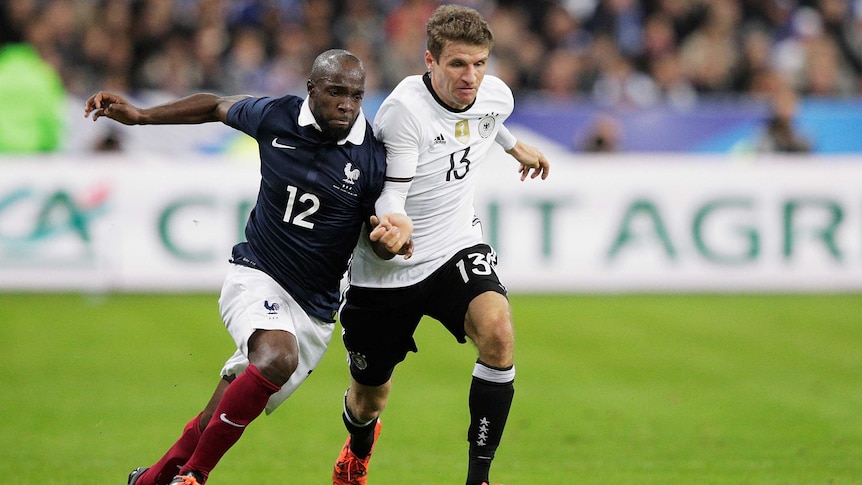 Thomas Mueller of Germany (R) is challenged by France's Lassana Diarra (L) at Stade de France.