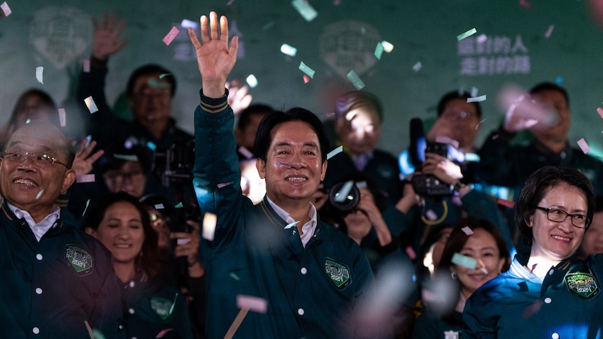 A man waving in a crowd