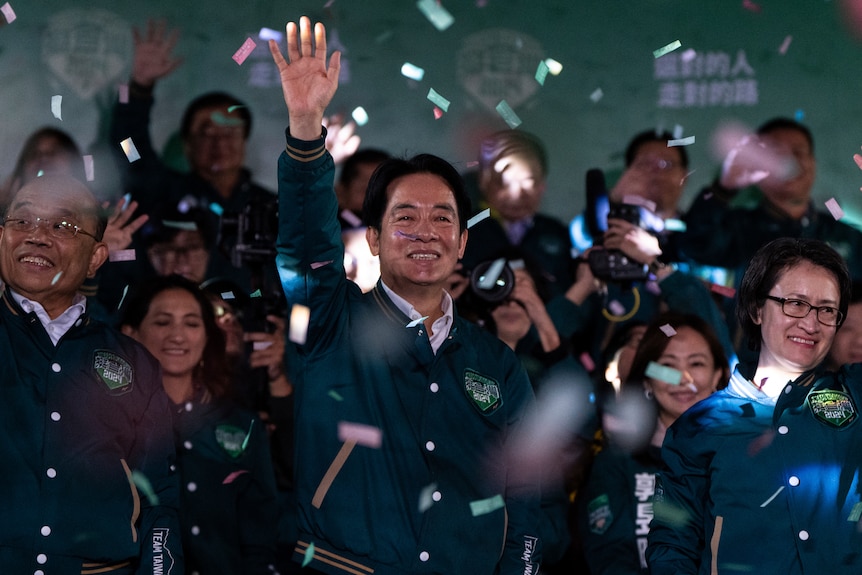 A man waving in a crowd