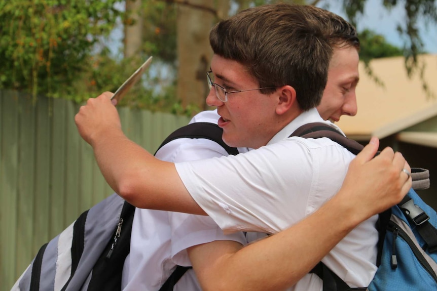 Missionaries share a hug