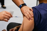 A person administers a vaccine