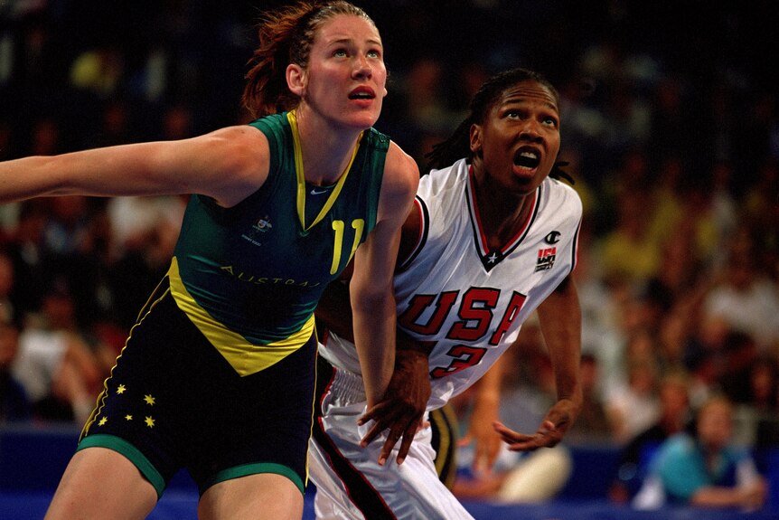 Lauren Jackson and Yolanda Griffith compete for the ball, looking up