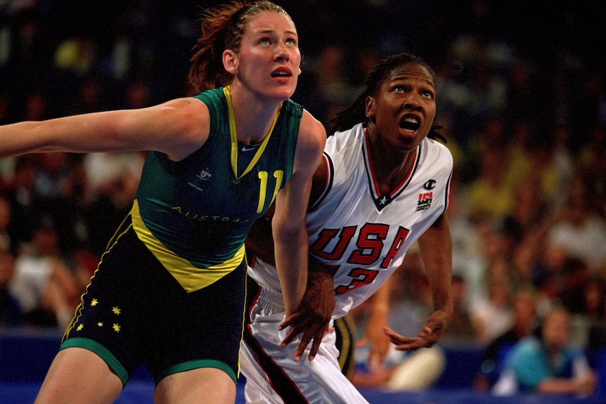 Lauren Jackson and Yolanda Griffith compete for the ball, looking up