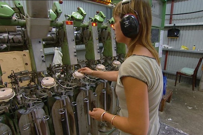 A woman works a machine at the Waverley Woollen Mill in Launceston.
