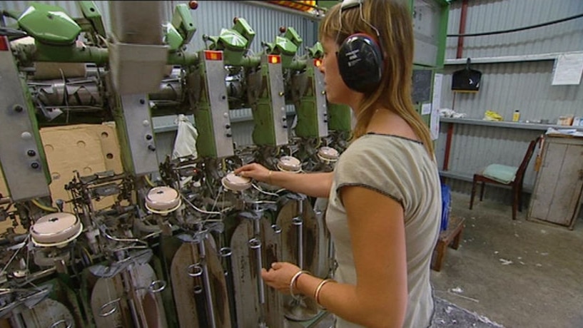 A woman works a machine at the Waverley Woollen Mill in Launceston.