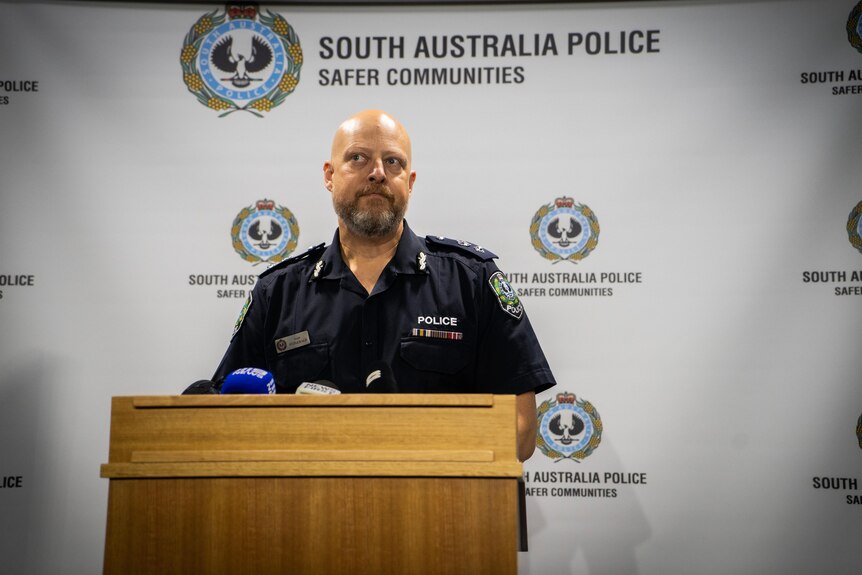 Police officer speaking at a press conference