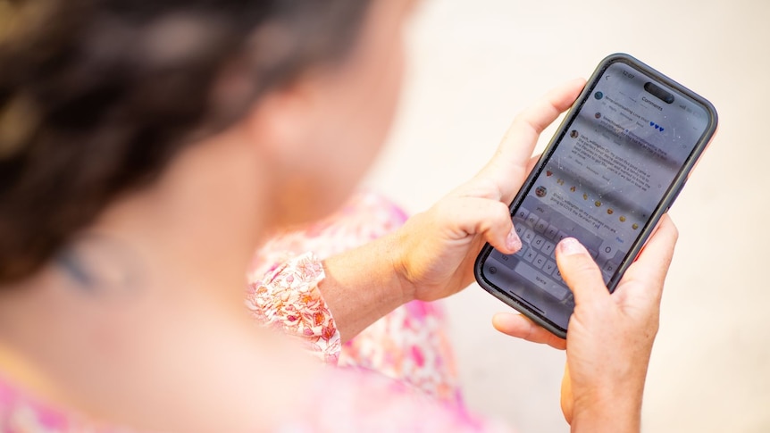 a girl holding a mobile phone