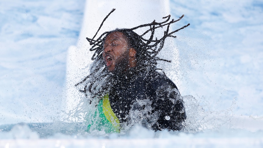 Nic Naitanui sahkes his hair as he comes out of the ice water at the Big Freeze at the 'G.