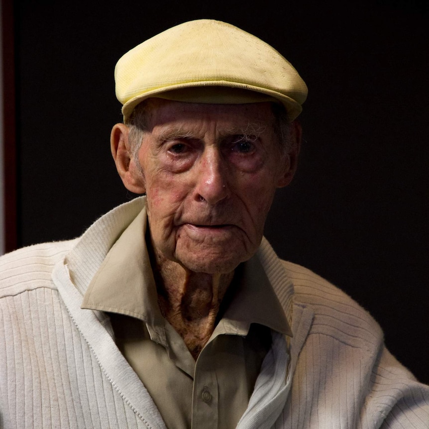 Elderly man with yellow flat cap