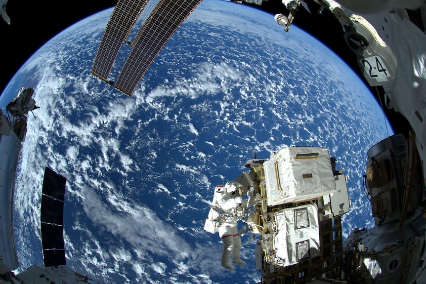 Astronaut doing a space walk outside the International Space Station.