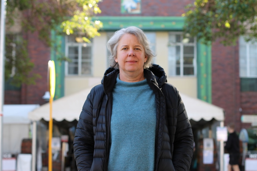 Jen McRae standing in front of entrance to hospital