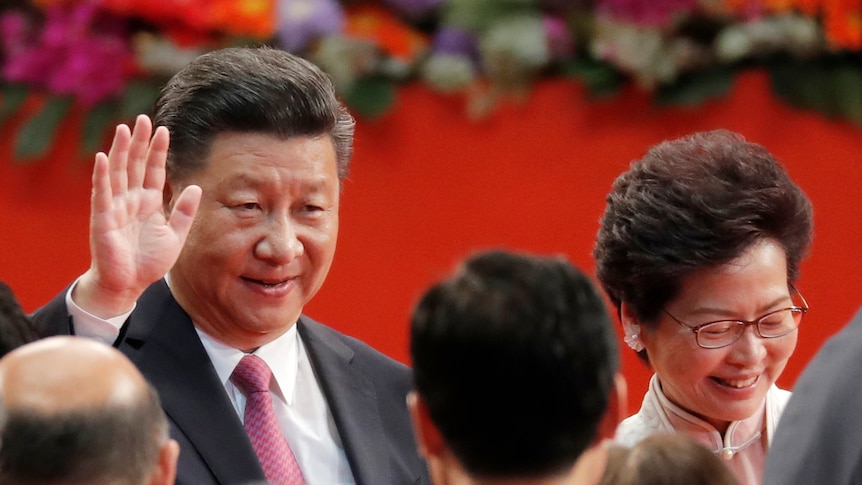 Chinese President Xi Jinping stands with former HK leader Carrie Lam