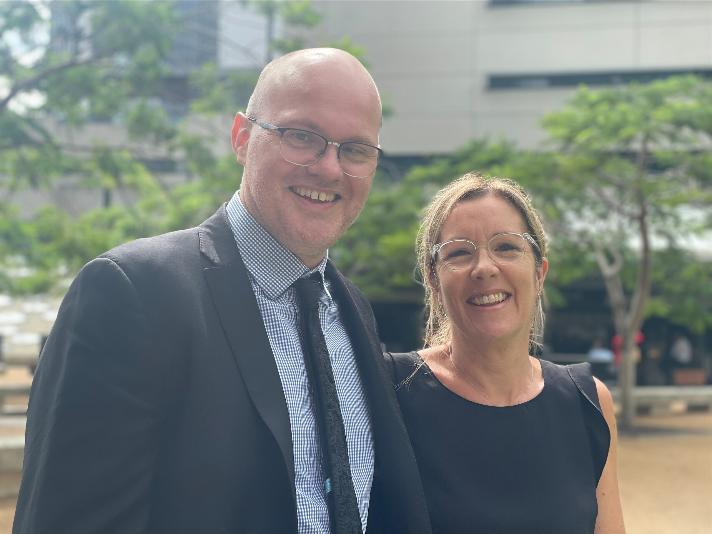 two people stand together