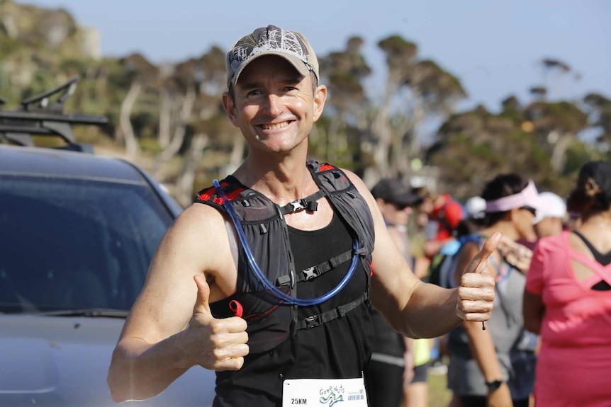 O'Brien in running gear give thumbs up before race.