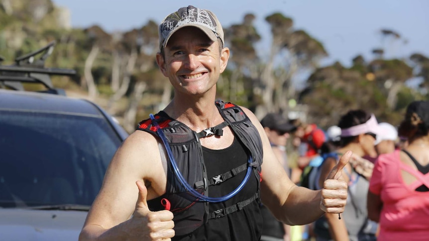 O'Brien in running gear give thumbs up before race.