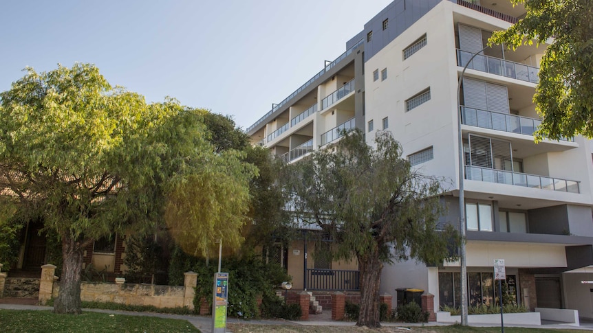 Two small houses next to a six-storey block, East Perth