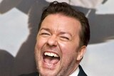 British actor Ricky Gervais laughs while posing for photos