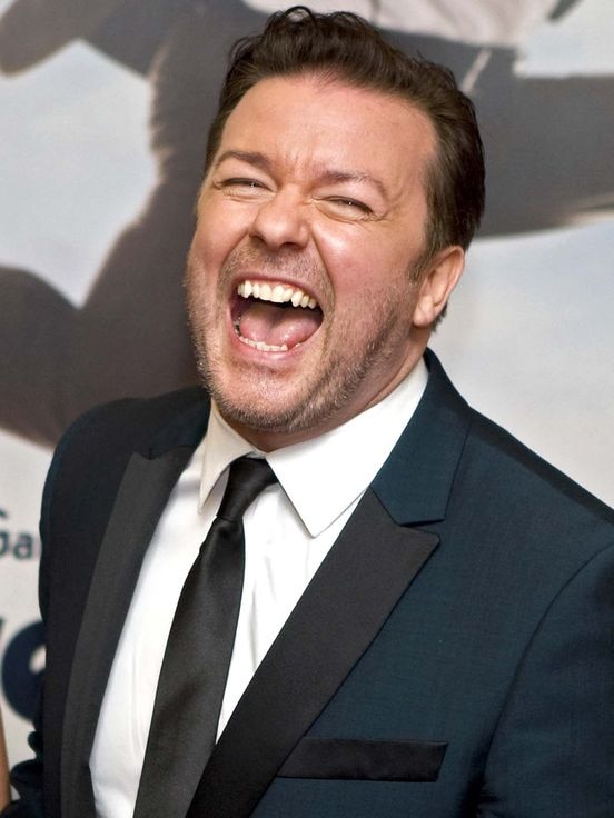 British actor Ricky Gervais laughs while posing for photos