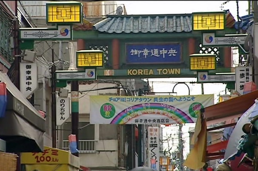 The entrance to Japan's Korean town is decorated with a banner featuring a rainbow with Japanese characters.