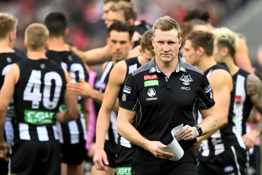 Collingwood coach Nathan Buckley walks off the ground during the match with Essendon at the MCG