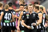 Collingwood coach Nathan Buckley walks off the MCG during a match with Essendon on July 8, 2017.