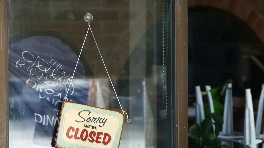 A shop front with a 'we're closed' sign
