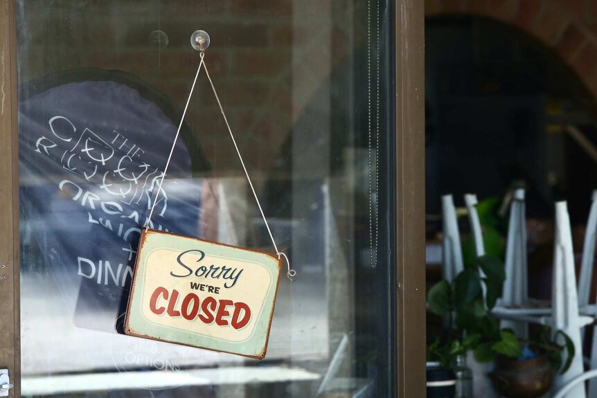A shop front with a 'we're closed' sign