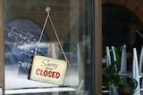 A shop front with a 'we're closed' sign