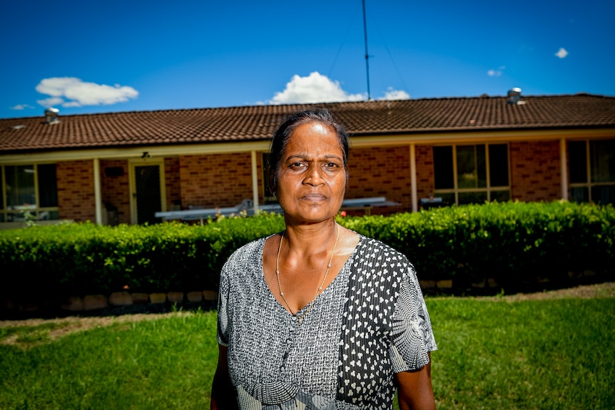 Rozeleen standing out the front of her single-storey brick home.