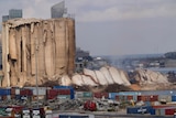 A collapsed portion of a silo in Beirut next to a still-standing portion.