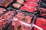Steak, chops and pork on display in butcher's window.