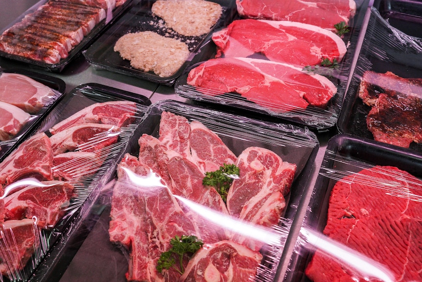 Steak, chops and pork on display in butcher's window.