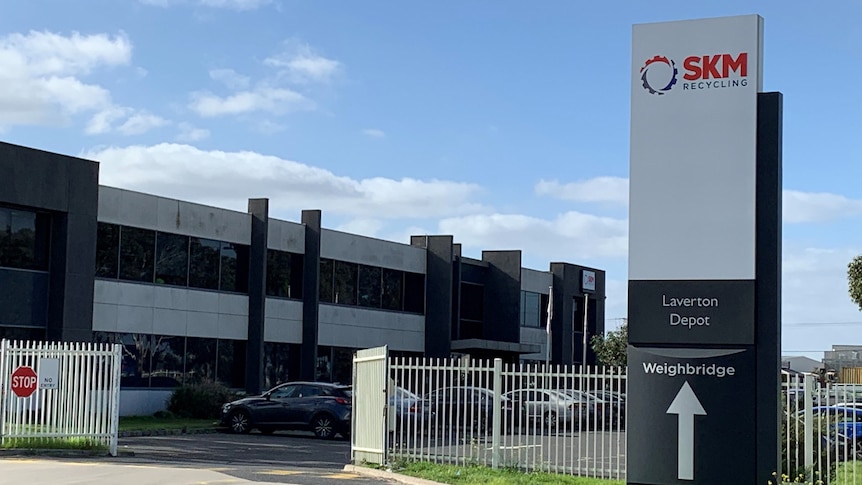 The exterior of an industrial building with a sign readying SKM Recycling Laverton Depot.