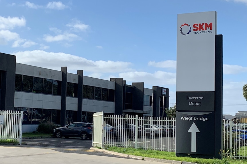 The exterior of an industrial building with a sign readying SKM Recycling Laverton Depot.
